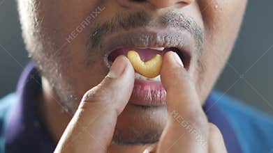 closeup of eating cashew nut