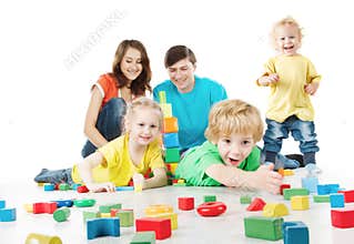 Happy family. Parents with three kids playing toys blocks