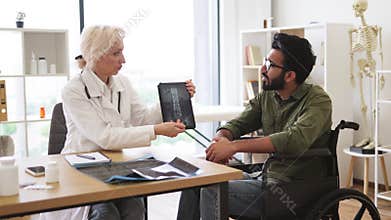 Young man looking on tablet with x-ray image carried by radiologist.