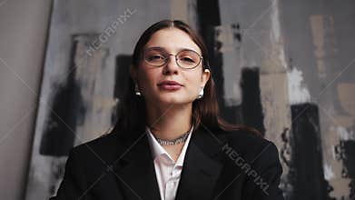 Cheerful young woman looking at cam talking laughing at home or office, happy female blogger speaking to webcam make