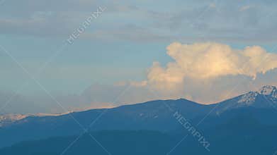Picturesque View Of Hazy Landscape Of Huge Rough Mountains With Green Trees.