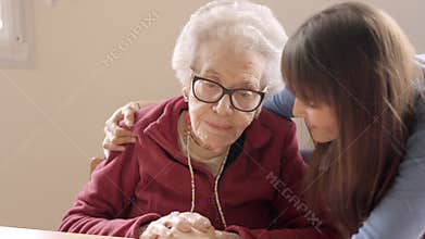 Granddaughter cheers up her sad grandmother in a nursing home