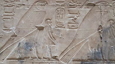 Ancient Egyptian hieroglyphs and bas-reliefs close-up in Temple of Seti I in Abydos, Egypt. Temple of Seti I