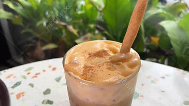 Top view a cup of Giang egg coffee on wood background. Vietnamese coffee in Ha Noi, Vietnam. Eggs are beaten with coffee