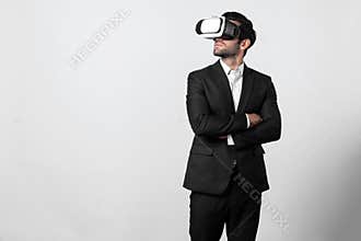 Smart business man crossing arms and standing at white background. Deviation.