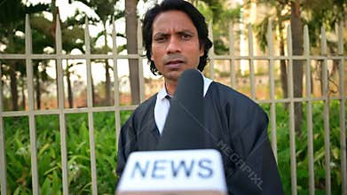 Legal adviser interviewed by news reporter outdoors