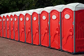 Row of Red Portable Toilets