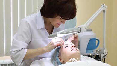 Cosmetician does disinfection of face after