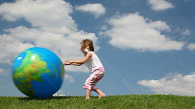 small girl trying to catch inflatable Earth ball
