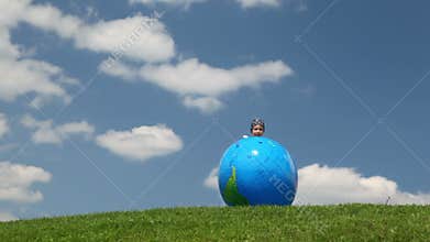 small girl playing globe looking inflatable ball