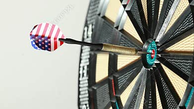 Dart hit directly into bulls eye, close up, side