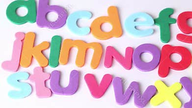 Multicolored letters arranged in three lines, in