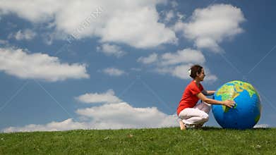 young lady coming to inflatable globe looking ball