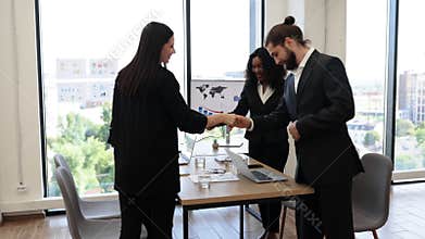 Business team meeting with handshake in modern office setting
