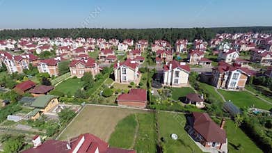 Panorama of cottage town near forest at sunny
