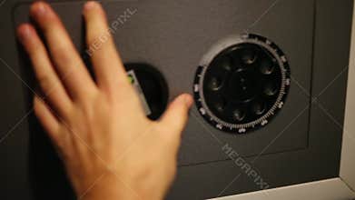 Hand closing door of small safe and turning lock