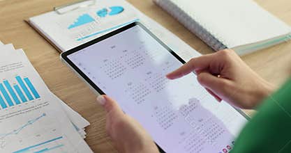 Using a tablet and calendar to plan events.