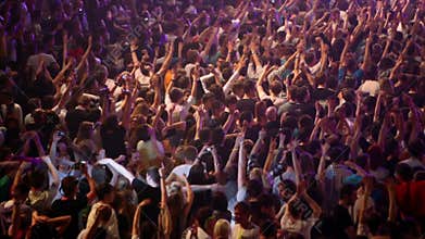 Lot of young people at rave party, view from