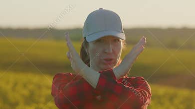 Portrait Of Young Female Looking At Camera With Serious Face And Shows Shows Hands Gesture No. One Farmer Woman Face