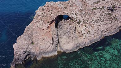 Natural windows in the rocks, Comino Island Malta, Close up drone shot