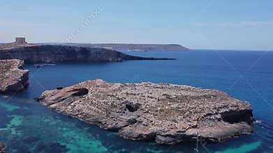 Natural windows in the rocks, Comino Island Malta, Close up revealing drone shot