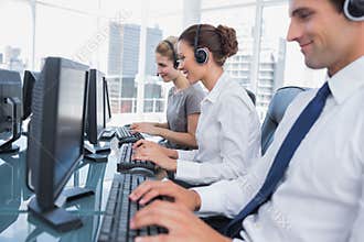 Group of call center agents working in line