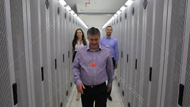 Three technicians walking in hallway