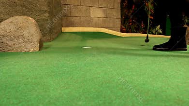 Girl playing golf indoor