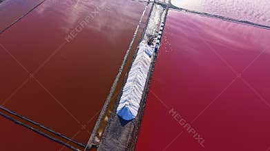 Vibrant hues of nature blend in salt pans during golden hour, showcasing the beauty of salt