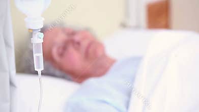 Elderly patient sleeping on a medical bed