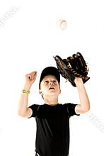 Young boy baseball player focusing on catching the ball
