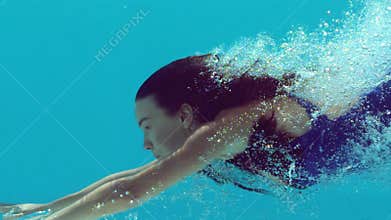 Woman swimming underwater
