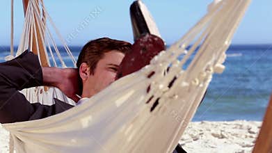 Businessman relaxing in a hammock