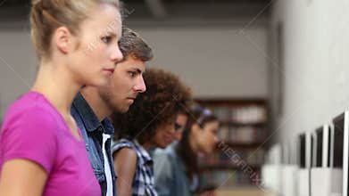 Students sitting in a row working on computers
