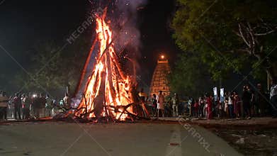 Holika Dahan, ritual bonfire, evening before the holi festival in India, symbol for burning the evil, triumph of good, Hampi,