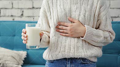 Woman Experiencing Stomach Pain After Drinking Milk, lactose intolerance concept, digestive health awareness
