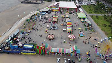 Lively amusement park panoramic view, Drone shot of bustling beachside amusement with families and attractions