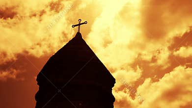 Timelapse of clouds passing by over tower of christian church