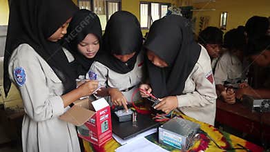 School students in Java, Indonesia, practice measuring DC electrical power