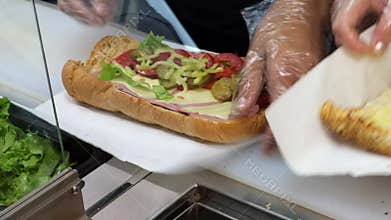 Preparing sandwich with ham and swiss cheese