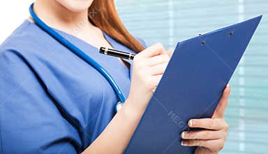 Nurse writing on a clipboard