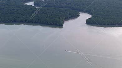 erial shot highlights boat gliding across Johor River