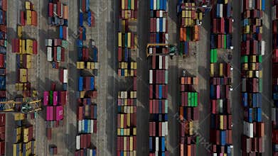 Erial view of colorful shipping containers in organized rows at a large port terminal yard
