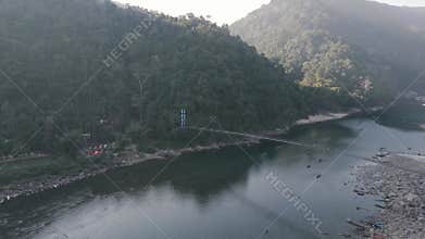 Aerial view of the suspension bridge and clear Umngot River in Shnongpdeng village, a tourist destination in Meghalaya, India