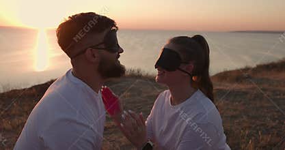 Gender party with blindfolded at sunset