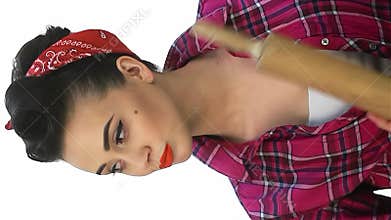 Fierce pin-up housewife confidently wielding a battledore