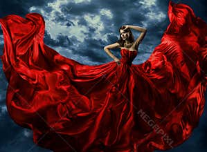 Woman in red evening dress, waving gown with flying long fabric