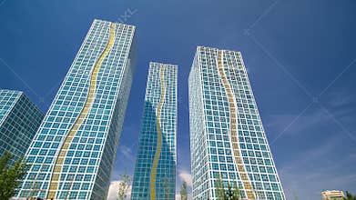 Modern towers of residential complex near Ishim River timelapse hyperlapse in Astana