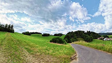 Footage of a panoramic camera pan of fields and meadows in the Bavarian Forest near the town of Grafenau, Germany