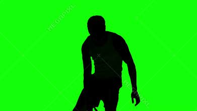 Silhouette of a man playing basket on green screen